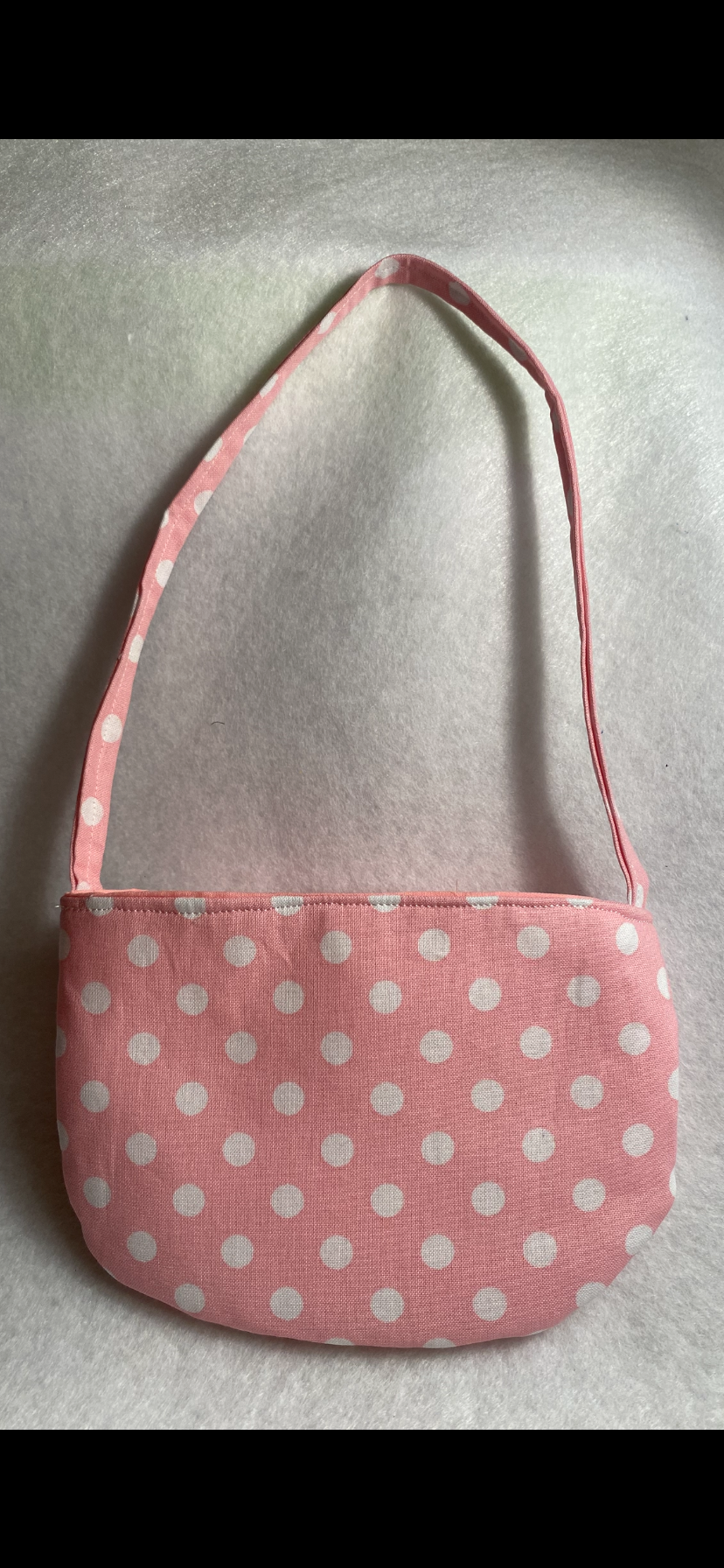 Pink pocketbook with white polkadots